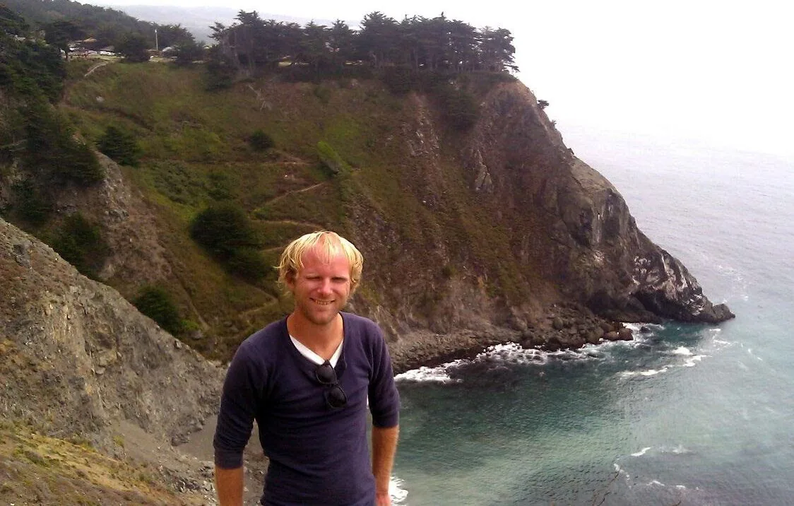 Dylan on a trail above the Pacific Ocean